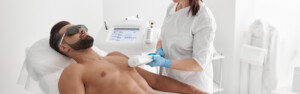 Laser hair removal on a man in clinic.