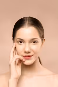 Young woman puts her fingers to her temple and smiles contentedly